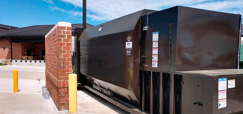 Cumberland Services stationary compactor on site.