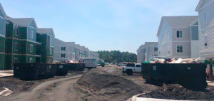Multiple Cumberland Services roll-off containers on subdivision construction site.
