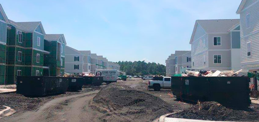 Multiple Cumberland Services roll-off containers on subdivision construction site.